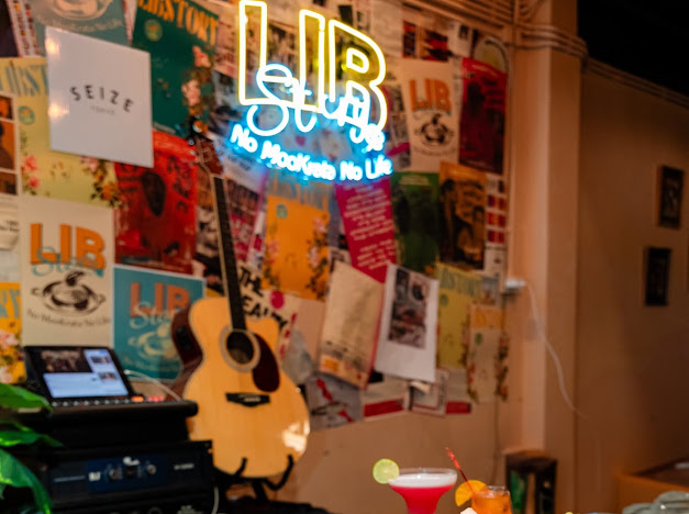 LIB STORY neon sign and guitar
